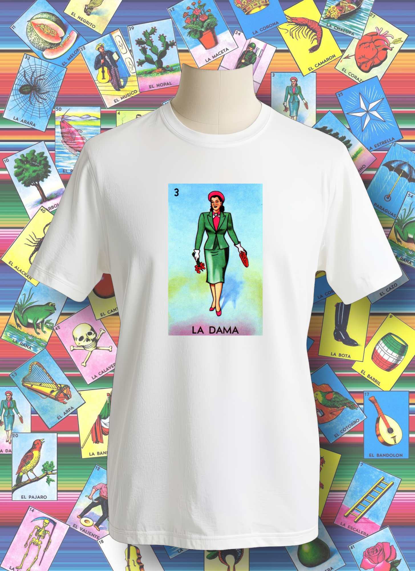 White t-shirt with 'La Dama' design on a colorful background of tarot card illustrations.