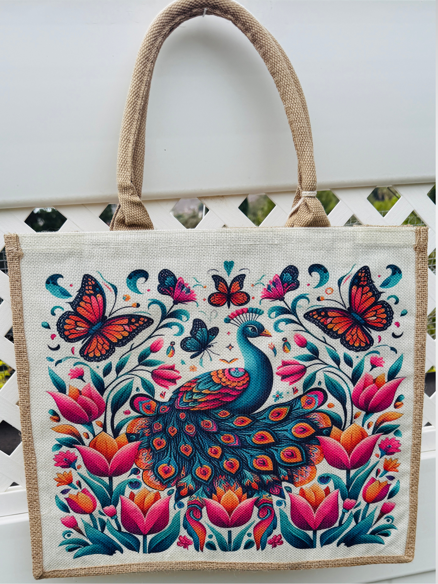 Tote bag with peacock and butterfly design on a white background