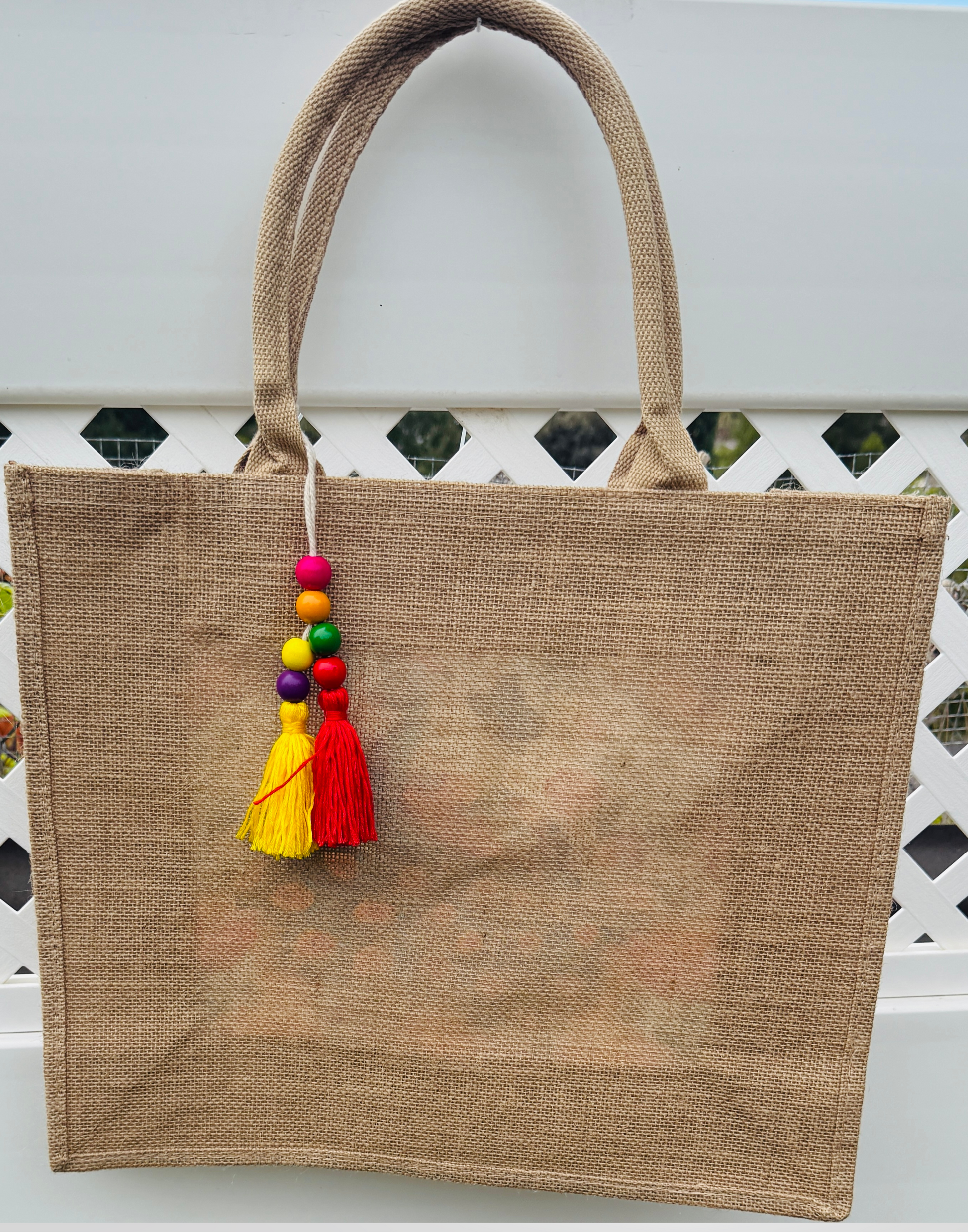 Jute bag with colorful tassels on a white background